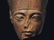 An Egyptian Brown Quartzite Head of the God Amen with features of the Pharaoh Tutankhamen. New Kingdom, 18th Dynasty, Reign of Tutankhamen, circa 1333-1323 B.C.