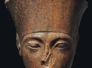 An Egyptian Brown Quartzite Head of the God Amen with features of the Pharaoh Tutankhamen. New Kingdom, 18th Dynasty, Reign of Tutankhamen, circa 1333-1323 B.C.