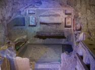 The large family tomb, cut into the rock of the hillside, with painted frescos and mosaic paving.