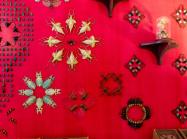 Jennifer Angus installation, a red wall with insects pinned to it arranged in intricate patterns