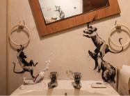Banksy rats run amok in a bathroom