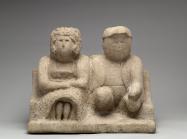 Edmonson, Bess and Joe, 1930-40. A a simple, stone sculpture of a couple sitting together, looking ahead. 