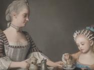 mother and daughter take tea 