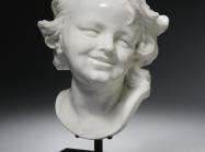 ceramic bust of a laughing child