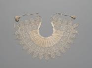 Detailed and petite lace collar. Unknown, 1610-1620, Standing Band (Collar) with Tassels, Cutwork, needle lace, reticello, punto in aria, embroidery, linen. Gift of Mrs. Edward S. Harkness, 1930. The Metropolitan Museum of Art. .