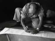 Isamu Noguchi working on a paper template for an Akari design, 1952. The Noguchi Museum Archives, 03603. 