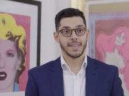 James Baskerville in front of prints