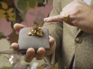 An expert shows a piece of jewelry