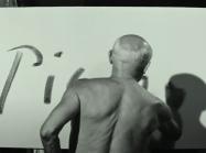 Still of Picasso signing his name in Le Mystère Picasso. Uploaded by Royal Academy of Arts to youtube under the title "Watch Picasso Make a Masterpiece"