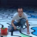 Haring painting the backdrop for the Palladium nightclub, 1985