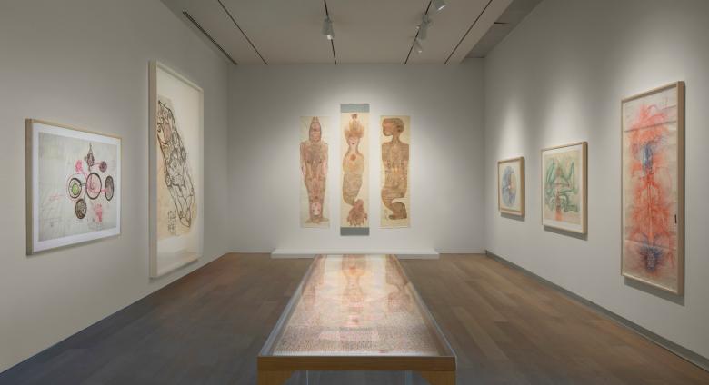 photo of a museum gallery with large works on art on white walls