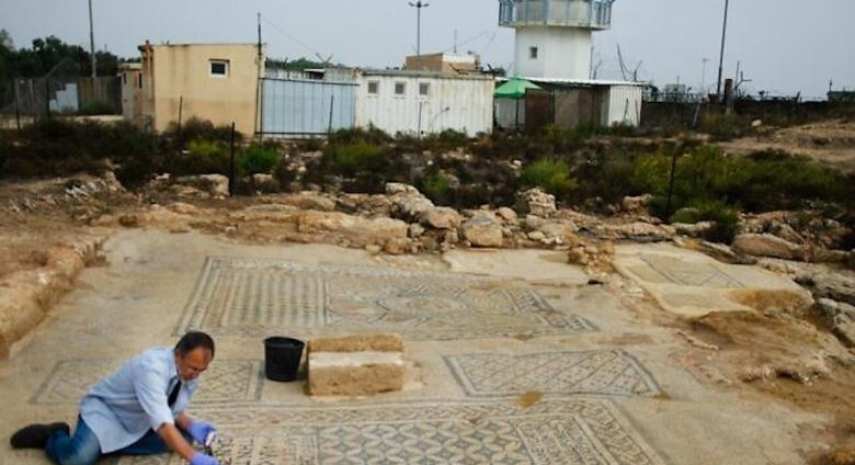 An Israel Antiquities Authority conservationist works on the 'Jesus' mosaic excavated at a prison in Megiddo in northern Israel, part of a structure from the third or fourth century that may be one of the earliest Christian churches. (Yoli Schwartz/IAA)
