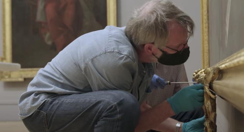 men working on art in masks