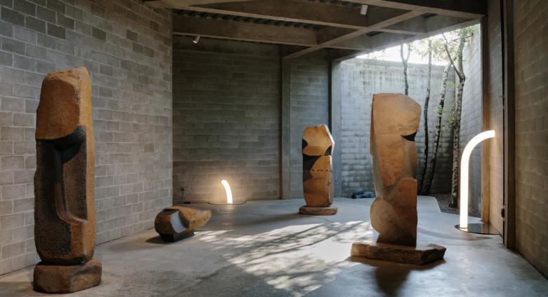 Objects of Common Interest, Tube Light I and Tube Light II, 2019, installed among Isamu Noguchi’s monumental late-career basalt sculptures in The Noguchi Museum’s indoor-outdoor galleries.