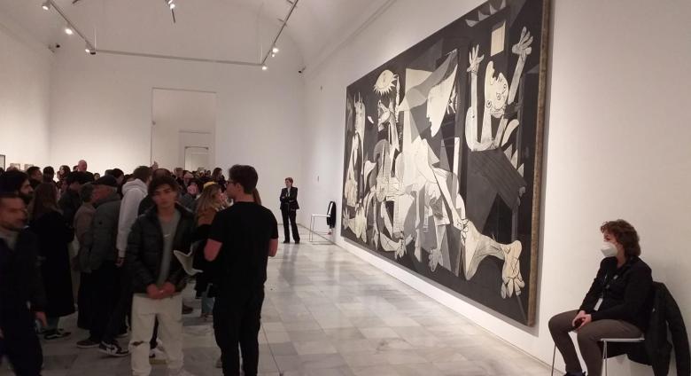 Visitors looking at Pablo Picasso’s Guernica. Source.