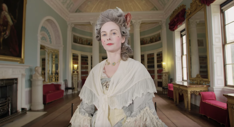 Woman in Georgian costume looks at camera