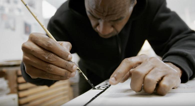 Marlon Mullen at work on painting