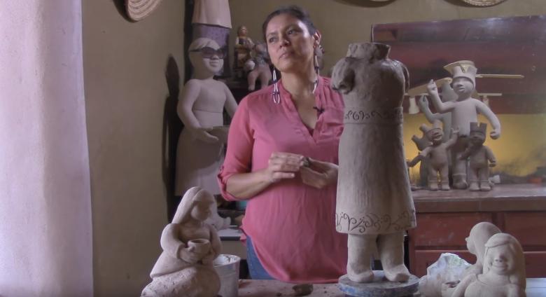 Artist works on sculpture in her studio