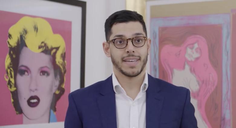 James Baskerville in front of prints