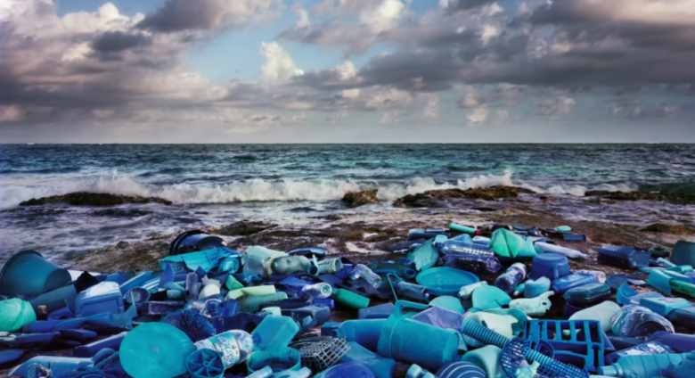 photograph of blue plastic arranged on a beach