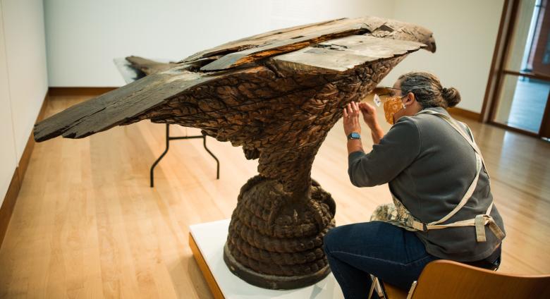 Pizzagalli Director of Conservation Nancie Ravenel at work conserving folk art sculpture by Laban Smith Beecher from the mid-19th century. Photography by Andy Duback