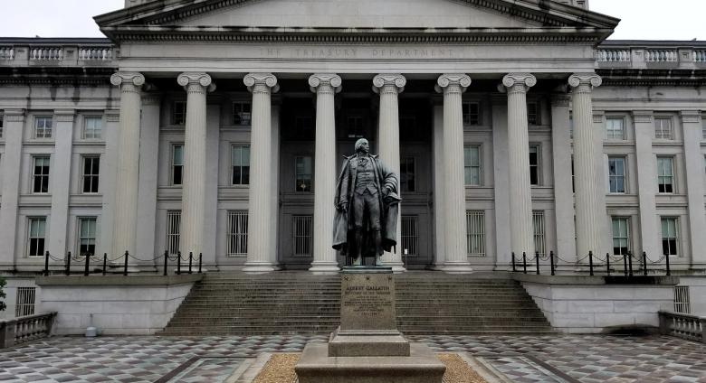 neoclassical building with columns and statue in front