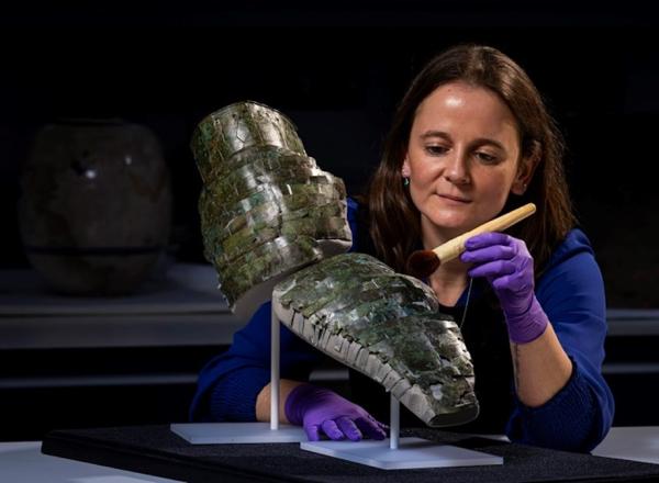 Conservator Bethan Bryan with the Roman arm guard