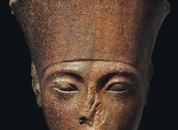 An Egyptian Brown Quartzite Head of the God Amen with features of the Pharaoh Tutankhamen. New Kingdom, 18th Dynasty, Reign of Tutankhamen, circa 1333-1323 B.C.