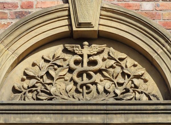 caduceus symbol above a doorway