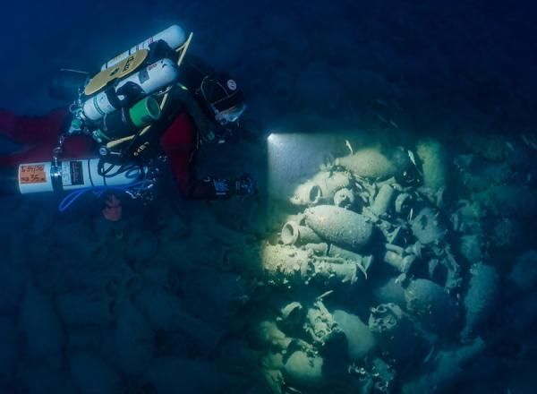 An archeologist examines an underwater site. Source.