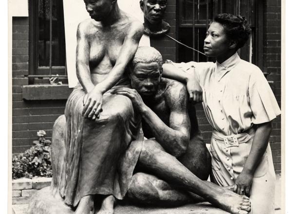 Augusta Savage posing with her sculpture Realization, created as part of the Works Progress Administration's Federal Art Project. Photo by Andrew Herman, circa 1938. Wikimedia Commons