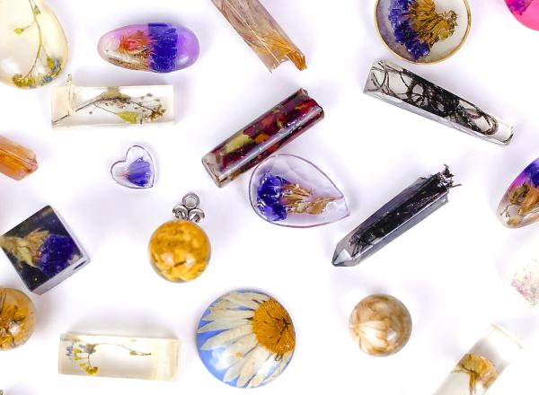 Various resin charms of different shapes and colors on a white background.