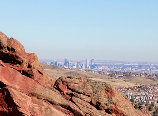 A view of denver over red rocks