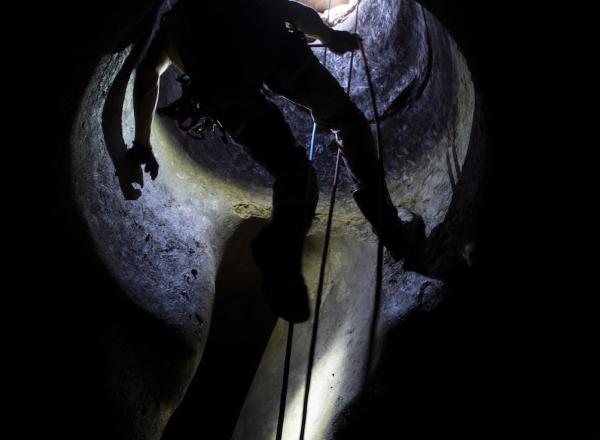 Fabio Fiocchi descends on a roped safety system into a cistern cavern at Vulci. To do such requires training and safety certifications. Credit- Danielle Vander Horst.
