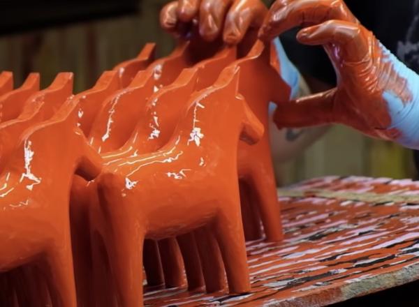 red sculpture horses being painted