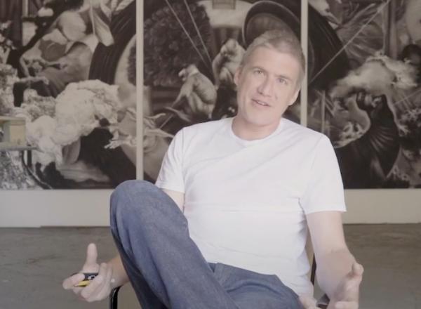 Hugo Wilson sitting in front of work in his UK studio