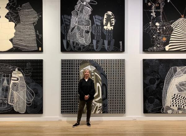 Sarah Amos in front of "Sarah Amos: Chalk Lines" at CUE Art Foundation