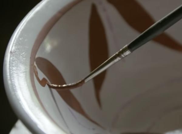 brush gently paints decoration inside of bowl