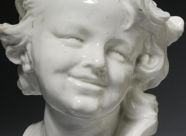 ceramic bust of a laughing child