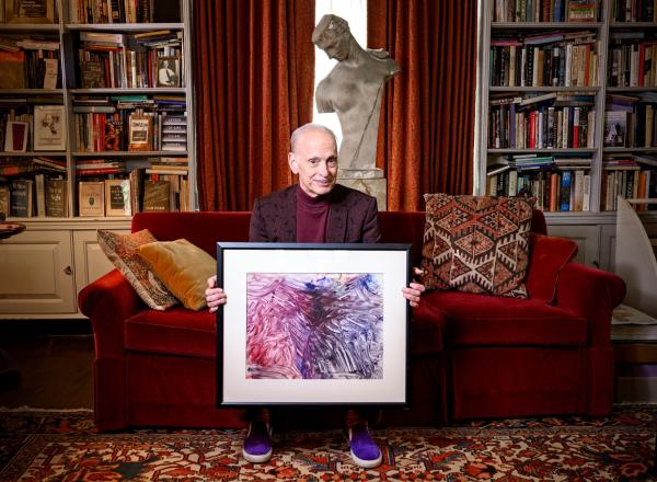 John Waters at home with his "monkey masterpiece."