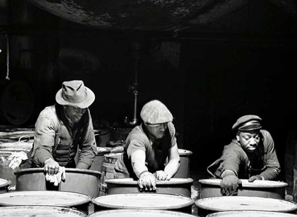"Workmen stacking drums of grease ready for shipment.", March 1944