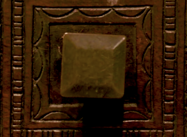 Detail of carved chest, showing two knobs