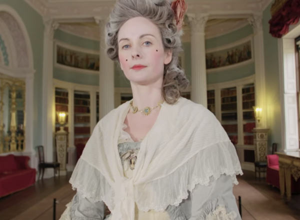 Woman in Georgian costume looks at camera