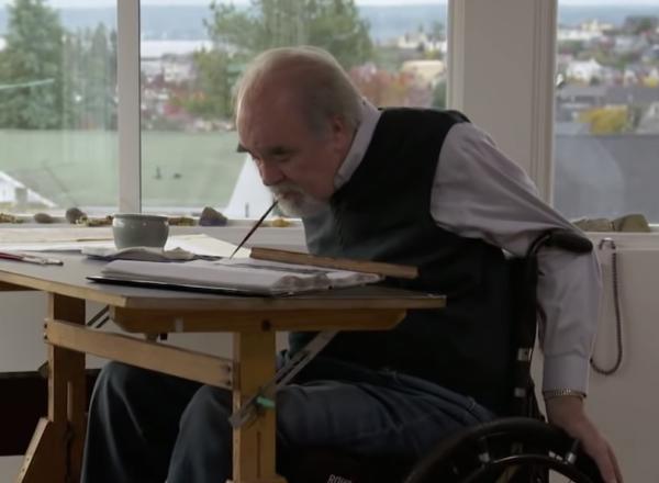 Brom Wikstrom painting in front of windows