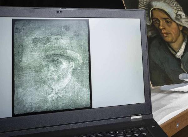 Senior Conservator Lesley Stevenson views Head of a Peasant Woman alongside an x-ray image of the hidden Van Gogh self-portrait. Photograph by Neil Hanna 