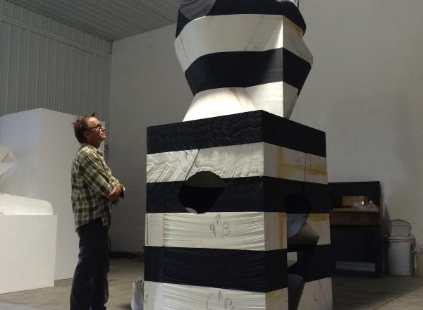 Portrait of Mel Kendrick with his artwork