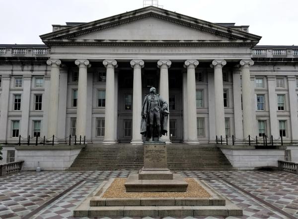 neoclassical building with columns and statue in front