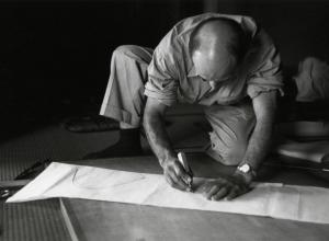 Isamu Noguchi working on a paper template for an Akari design, 1952. The Noguchi Museum Archives, 03603.