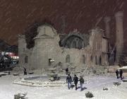 People walk next to a mosque destroyed by an earthquake in Malatya, Turkey, Monday, Feb. 6, 2023. A powerful quake has knocked down multiple buildings in southeast Turkey and Syria and many casualties are feared. (DIA images via AP)