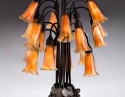 Tiffany Glass & Decorating Company, Eighteen-light Lily Table Lamp, prior to 1902, bronze, blown glass.